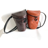 2 small leather bags in brown and orange